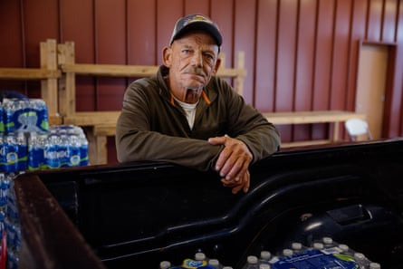 Man stands for portrait next to pickup truck trunk
